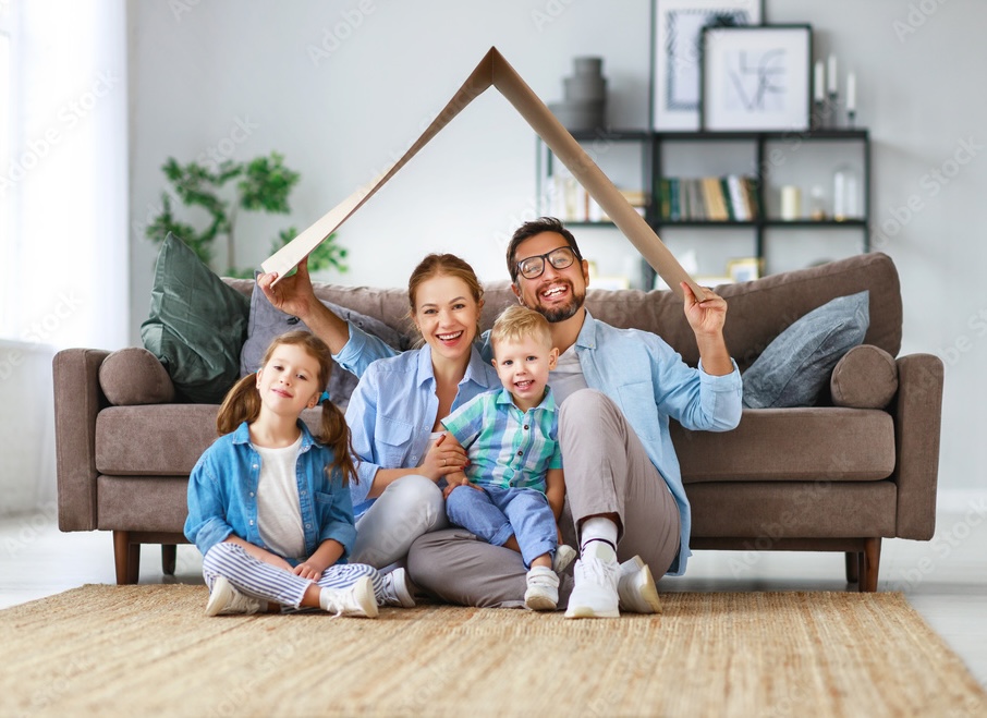 Happy family in front of their new home
